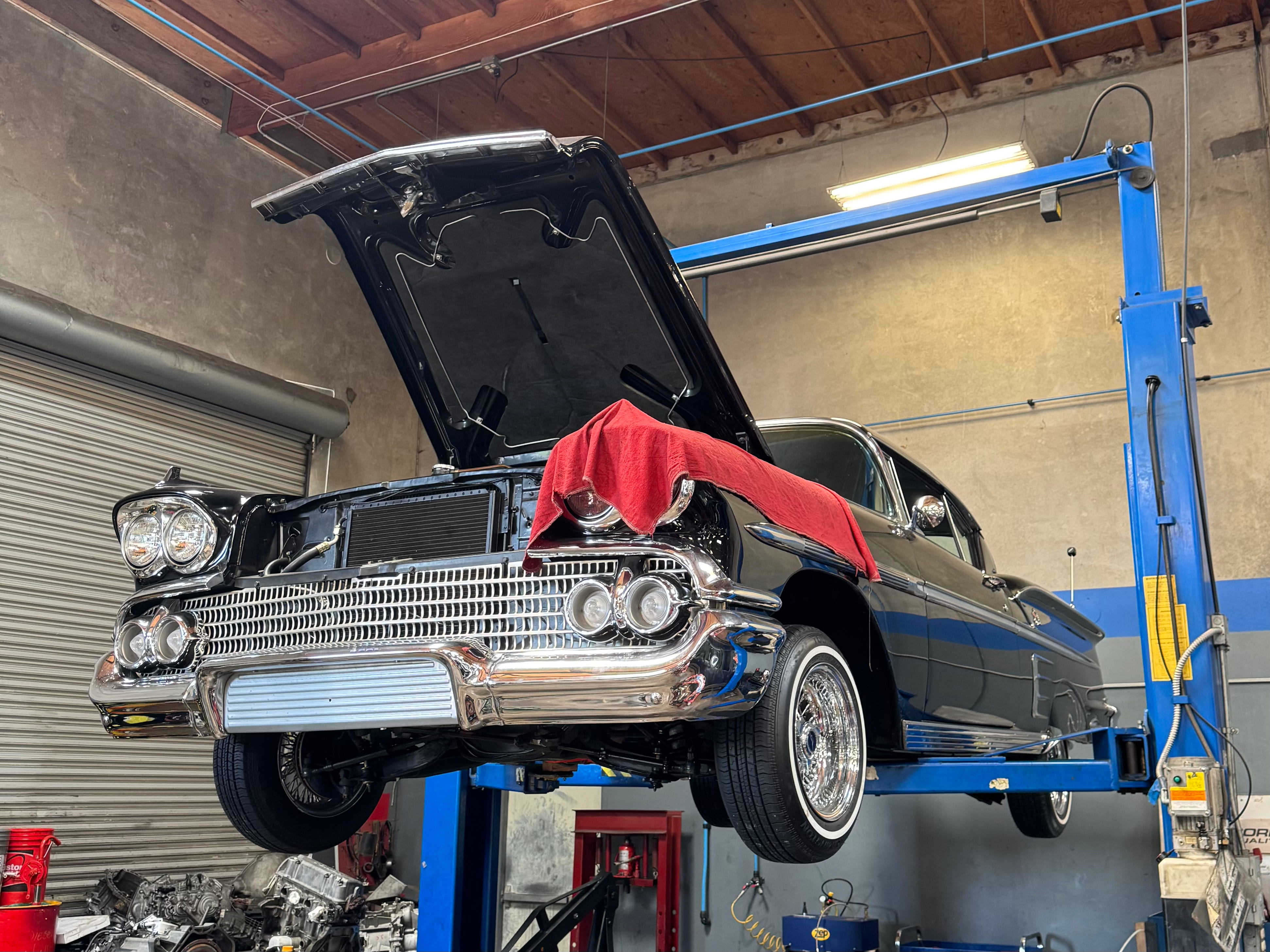 Classic car receiving expert repair on a lift at Miramar Transmission