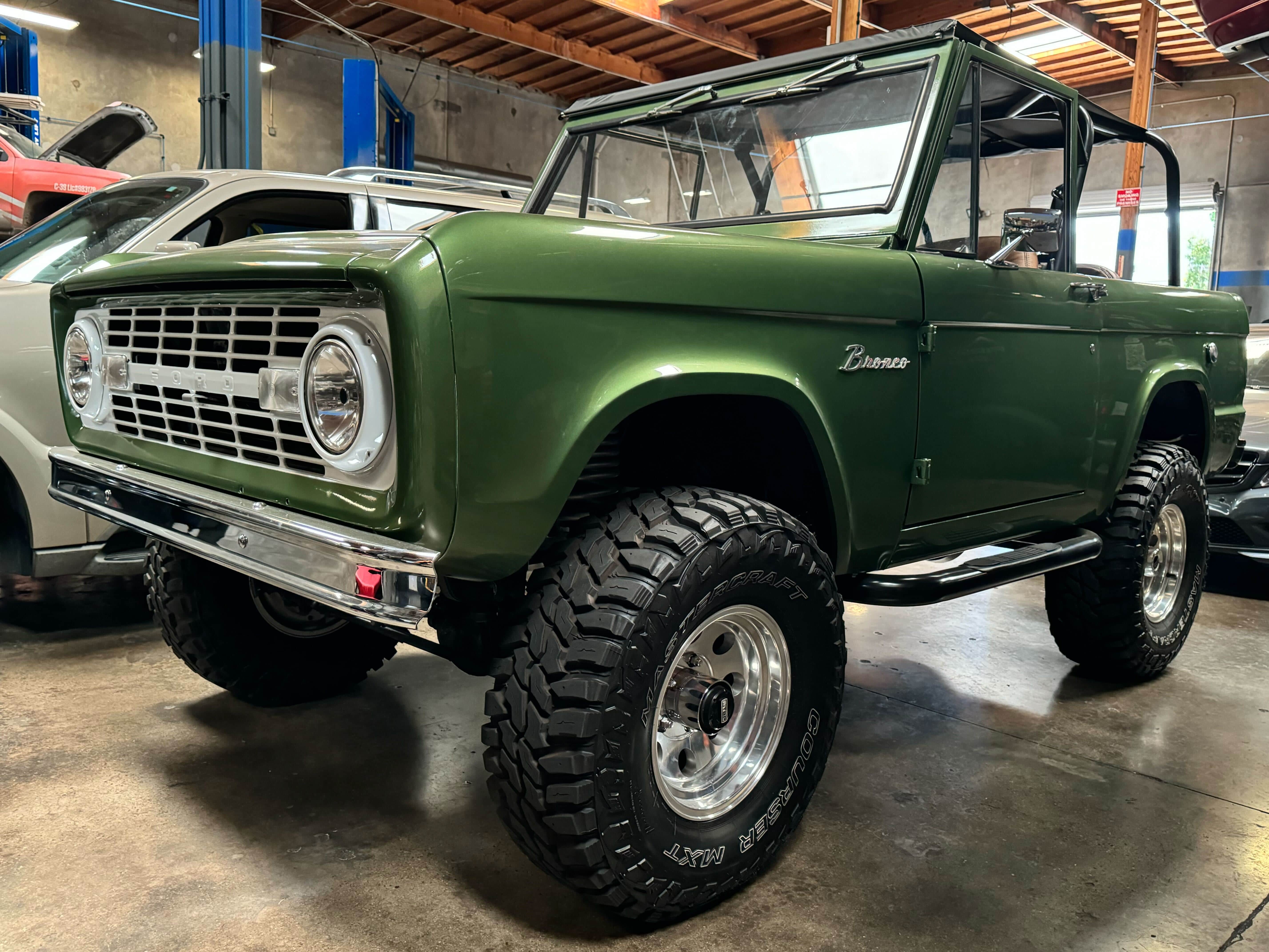 Restored green Ford Bronco inside the Miramar repair shop